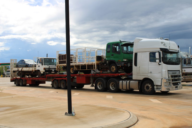 Isuzu Trucks and a car being transported from darwin to melbourne